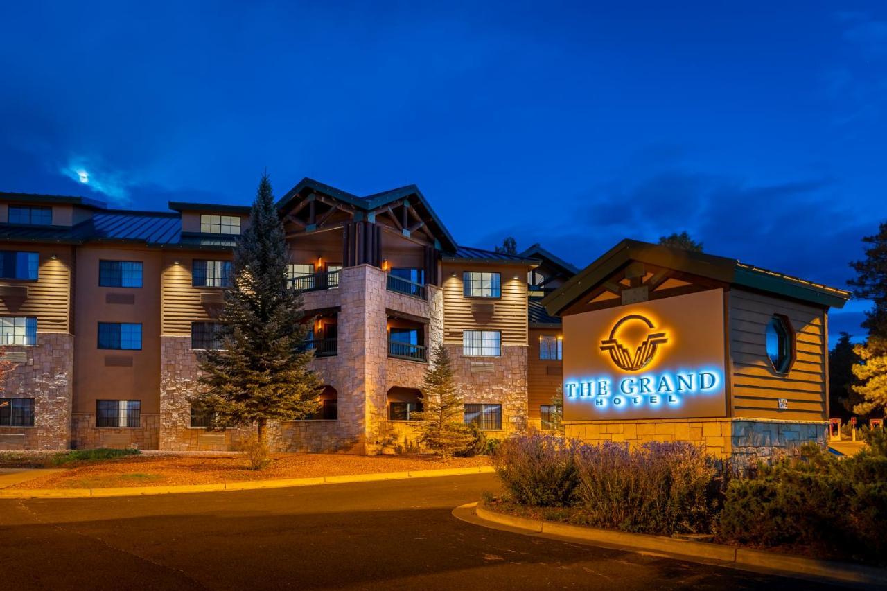 The Grand Hotel At The Grand Canyon Тусан Екстериор снимка The image shows a building featuring a sign that reads "The Grand." The structure appears to be a hotel or lodge, characterized by a combination of stone and wooden features. It is illuminated with warm lighting, which creates an inviting atmosphere.